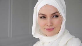 Portrait of muslim arabian woman wearing hijab, looking at camera and smiling. stock video Portrait of muslim arabian woman wearing hijab, looking at camera and smiling. stock video