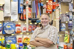 Portrait Of A Happy Mature Salesperson With Arms Crossed In Hardware Store Royalty Free Stock Images Portrait Of A Happy Mature Salesperson With Arms Crossed In Hardware Store Royalty Free Stock Images