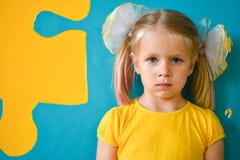 Portrait Of A Little Girl In Yellow Dress On A Yellow And Blue Background With A Puzzle Royalty Free Stock Photo Portrait Of A Little Girl In Yellow Dress On A Yellow And Blue Background With A Puzzle Royalty Free Stock Photo