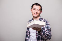 Portrait Of A Smiling Man Giving Book Stock Image