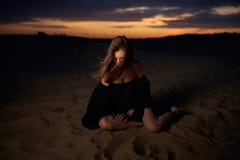 Portrait Of A Young Woman In A Black Dress Walking In The Desert Royalty Free Stock Photos Portrait Of A Young Woman In A Black Dress Walking In The Desert Royalty Free Stock Photos