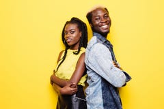 Portrait Of Afro American Couple Standing Back To Back Isolated Over Yellow Background Stock Photos Portrait Of Afro American Couple Standing Back To Back Isolated Over Yellow Background Stock Photos