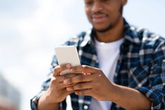 Portrait Of Afro Person Texting Sms On His Smart Phone Royalty Free Stock Photography