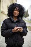 Portrait Of Attractive Afro Woman Using Mobile Phone In The Street Stock Photo Portrait Of Attractive Afro Woman Using Mobile Phone In The Street Stock Photo