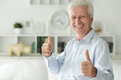 Portrait Of Happy Senior Man Showing Thumbs Up Stock Photo
