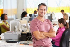 Portrait Of Man Standing In Busy Creative Office Royalty Free Stock Photography Portrait Of Man Standing In Busy Creative Office Royalty Free Stock Photography