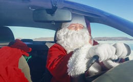 Portrait Of Santa Claus In The Car Stock Photography