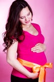 Portrait of pregnant woman holding her belly royalty free stock photography Portrait of pregnant woman holding her belly royalty free stock photography
