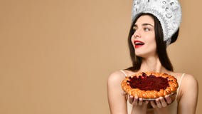 Portrait of a smiling woman holding pie stock images Portrait of a smiling woman holding pie stock images