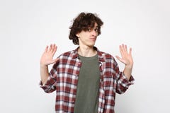 Portrait of puzzled young man in casual clothes looking camera, spreading hands, showing palms isolated on white royalty free stock photo Portrait of puzzled young man in casual clothes looking camera, spreading hands, showing palms isolated on white royalty free stock photo