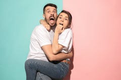 Portrait of the scared man and woman on pink and blue Stock Photos Portrait of the scared man and woman on pink and blue Stock Photos