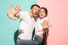 Portrait of the scared man and woman on pink and blue Royalty Free Stock Photography Portrait of the scared man and woman on pink and blue Royalty Free Stock Photography