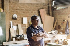 Portrait of senior carpenter. Standing in his workshop. stock images Portrait of senior carpenter. Standing in his workshop. stock images