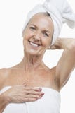 Portrait of senior woman wrapped in towels against white background Royalty Free Stock Photography Portrait of senior woman wrapped in towels against white background Royalty Free Stock Photography