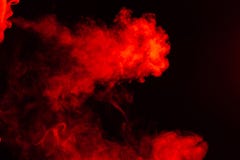 Portrait of a side mouth part of guys face with a colored backlight of monochrome smoking a vape and exhaling white red in royalty free stock images Portrait of a side mouth part of guys face with a colored backlight of monochrome smoking a vape and exhaling white red in royalty free stock images