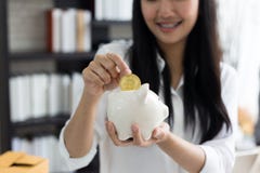 Portrait of smiling asian young woman hold piggy bank and Coin royalty free stock images Portrait of smiling asian young woman hold piggy bank and Coin royalty free stock images