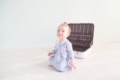 Little girl is playing with a white suitcase royalty free stock images Little girl is playing with a white suitcase royalty free stock images