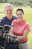 Portrait of smiling couple playing golf