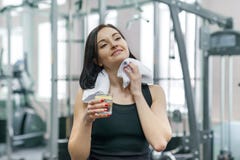 Portrait of smiling fitness woman with glass of water with lemon, woman in sportswear after fitness classes drinking water in gym stock photo Portrait of smiling fitness woman with glass of water with lemon, woman in sportswear after fitness classes drinking water in gym stock photo
