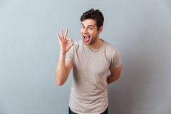 Portrait of a smiling happy man showing ok gesture stock images Portrait of a smiling happy man showing ok gesture stock images