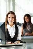 Portrait of smiling pretty young business woman sitting on workplace. royalty free stock images Portrait of smiling pretty young business woman sitting on workplace. royalty free stock images