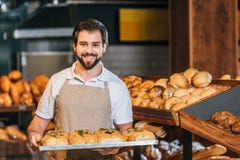 portrait of smiling shop assistant arranging fresh pastry royalty free stock photos portrait of smiling shop assistant arranging fresh pastry royalty free stock photos
