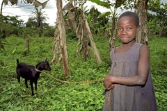 Portrait of smiling Ugandan goatherd with goat stock image Portrait of smiling Ugandan goatherd with goat stock image