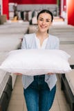 portrait of smiling woman showing pillow stock photos portrait of smiling woman showing pillow stock photos
