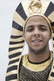 Portrait of smiling young man wearing a headdress from ancient Egypt, studio shot stock photography Portrait of smiling young man wearing a headdress from ancient Egypt, studio shot stock photography