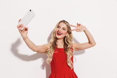 https://thumbs.dreamstime.com/t/portrait-smiling-young-woman-red-dress-standing-isolated-over-white-background-looking-away-taking-selfie-showing-peace-136079643.jpg
