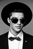 Portrait of a stylish young man in hat wearing elegant suit and sunglasses. Stock Images Portrait of a stylish young man in hat wearing elegant suit and sunglasses. Stock Images