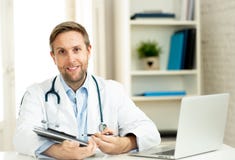 Portrait of successful specialist doctor working in hospital office looking happy and confident stock images Portrait of successful specialist doctor working in hospital office looking happy and confident stock images