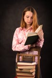 Portrait of a teenager girl reading book. Stack of books. royalty free stock photos Portrait of a teenager girl reading book. Stack of books. royalty free stock photos