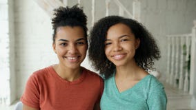 Portrait of two beautiful african american girls laughing and looking into camera at home royalty free stock photo Portrait of two beautiful african american girls laughing and looking into camera at home royalty free stock photo