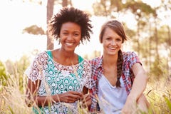 Portrait Of Two Smiling Young Women Sitting In Countryside Royalty Free Stock Images Portrait Of Two Smiling Young Women Sitting In Countryside Royalty Free Stock Images