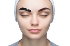 Portrait of a woman with beautiful, well-groomed eyebrows, makeup artist applies paint henna on eyebrows royalty free stock photography Portrait of a woman with beautiful, well-groomed eyebrows, makeup artist applies paint henna on eyebrows royalty free stock photography