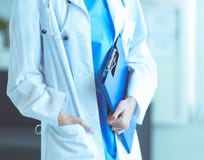 Portrait of woman doctor with folder at hospital corridor stock photography Portrait of woman doctor with folder at hospital corridor stock photography