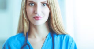 Portrait of woman doctor with folder at hospital corridor stock photo Portrait of woman doctor with folder at hospital corridor stock photo