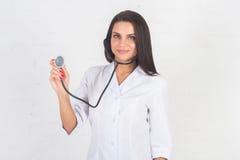 Portrait of woman doctor at hospital corridor, holding tablet computer, looking camera, smiling. stock image Portrait of woman doctor at hospital corridor, holding tablet computer, looking camera, smiling. stock image
