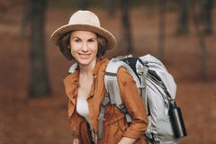 Portrait woman traveler with backpack looking at amazing forest, travel concept, space for text, atmospheric epic moment stock photos Portrait woman traveler with backpack looking at amazing forest, travel concept, space for text, atmospheric epic moment stock photos
