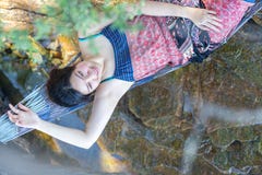 Portrait of young Asia beautiful girl relaxing on hammock on the stock photo Portrait of young Asia beautiful girl relaxing on hammock on the stock photo