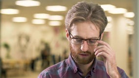 Portrait of young attractive serious guy, trying to find an idea how to solve a difficult problem on the background of stock footage Portrait of young attractive serious guy, trying to find an idea how to solve a difficult problem on the background of stock footage