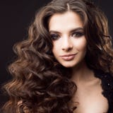 Portrait of a young attractive woman with gorgeous curly hair. Attractive brunette stock image Portrait of a young attractive woman with gorgeous curly hair. Attractive brunette stock image