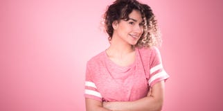 Portrait of a beautiful cheerful girl with curly hair on a pink background stock photography Portrait of a beautiful cheerful girl with curly hair on a pink background stock photography