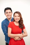 Portrait of a young couple hugging and standing against white background stock photos Portrait of a young couple hugging and standing against white background stock photos