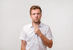 Portrait of young european man with sad face expression isolated on gray background stock images Portrait of young european man with sad face expression isolated on gray background stock images