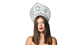 Portrait of young girl model in kokoshnik hat with natural makeup and long blowing hair isolated . Looking at camera. royalty free stock images Portrait of young girl model in kokoshnik hat with natural makeup and long blowing hair isolated . Looking at camera. royalty free stock images