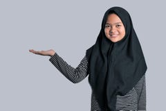 Portrait of a young girl wearing islamic headscarf showing blank area for sign or copyspase royalty free stock images Portrait of a young girl wearing islamic headscarf showing blank area for sign or copyspase royalty free stock images