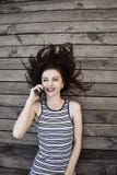 Portrait of young happy smiling businesswoman with smartphone outdoors as symbol of good news, freelance, success and wealth stock photo Portrait of young happy smiling businesswoman with smartphone outdoors as symbol of good news, freelance, success and wealth stock photo