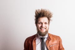 Portrait of a young hipster man with messy hairstyle in a studio. Copy space. royalty free stock image Portrait of a young hipster man with messy hairstyle in a studio. Copy space. royalty free stock image